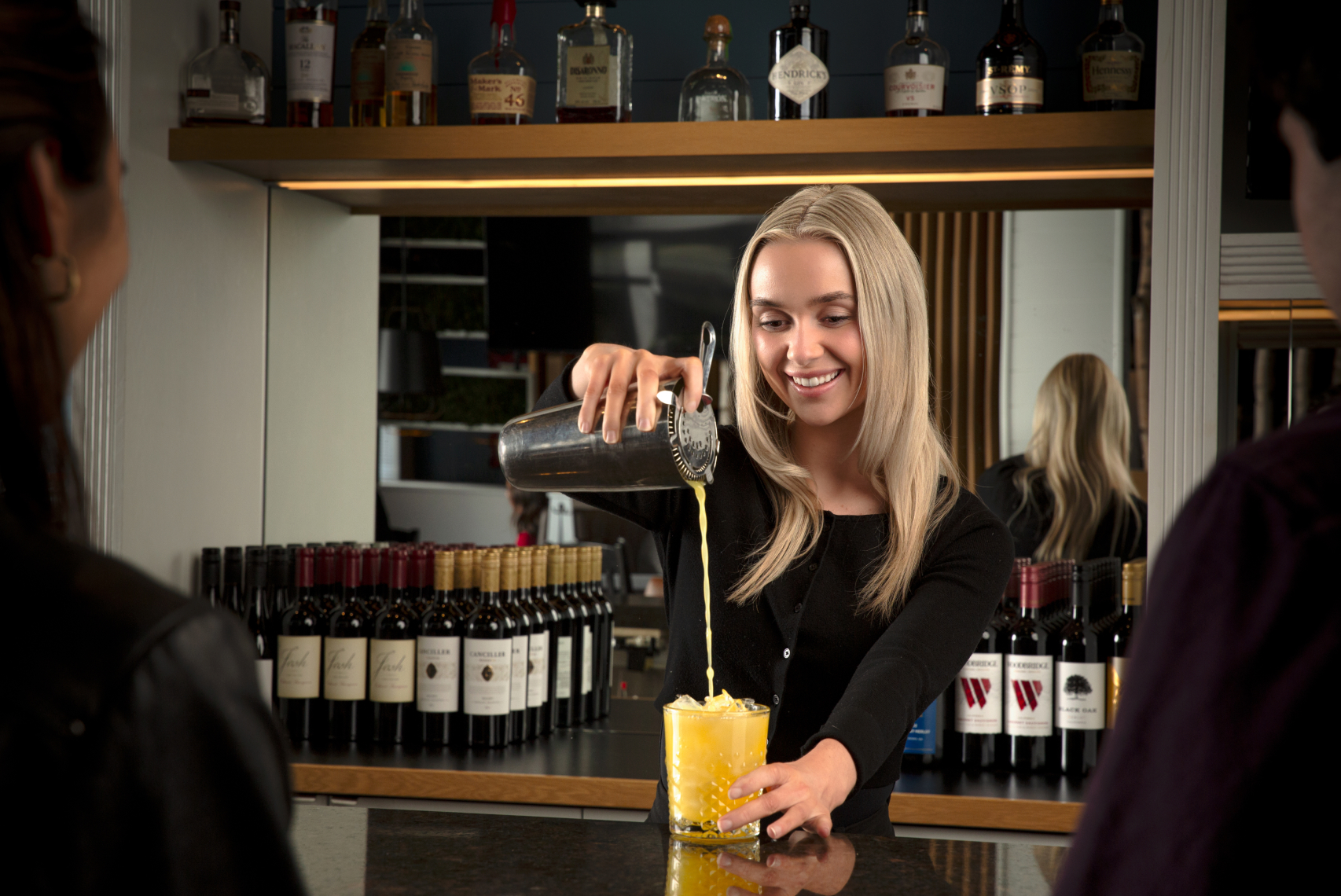 Image of Turtle Jack's bartender pouring a cocktail.